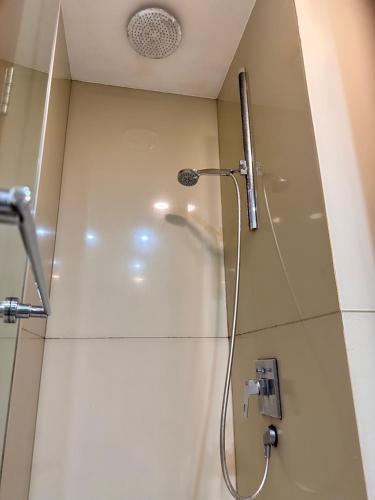eine Dusche mit Duschkopf in einem Badezimmer in der Unterkunft Soho Suites KLCC By Grand Suites KL in Kuala Lumpur