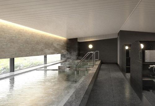 a bathroom with a pool of water in a building at Hotel Emion Sapporo in Sapporo