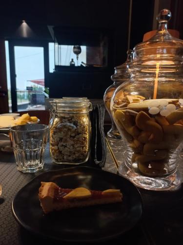 a table with a plate of food and a jar of nuts at Le Maginot Relais in Castelvetro Piacentino