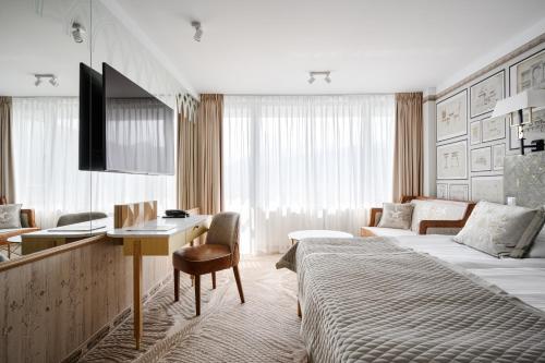 a hotel room with a bed and a desk at Bachleda Hotel Kasprowy in Zakopane