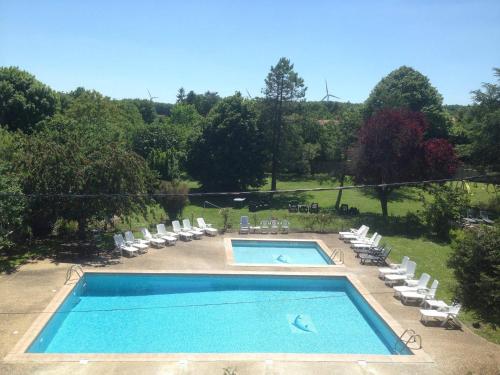 a swimming pool with lounge chairs at 8 Gite Complex, 53 People maximum , Marriage, Birthdays, family get togethers in Doeuil-sur-le-Mignon