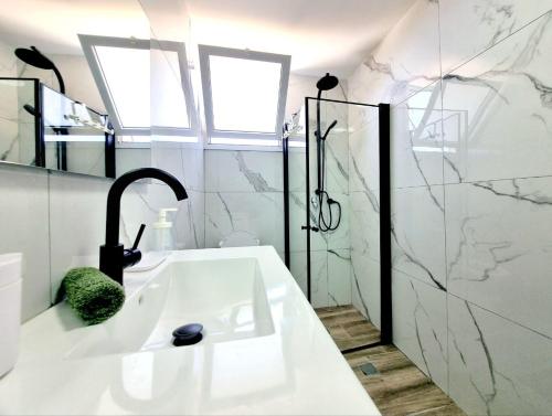 uma casa de banho branca com um lavatório e um chuveiro em "Robert Sold Zugit" from Shneider apartments em Qiryat Shemuʼel