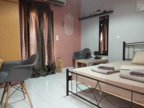a bedroom with a bed and a table and chairs at Cozy studio flat 1 bedroom-Very central location in Mytilini