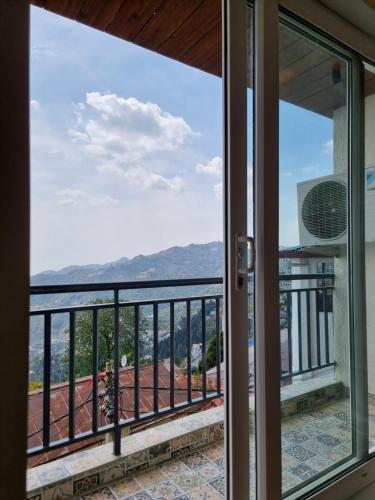 a view from the balcony of a house at Vaydantaa - Luxury Boutique Resort Mussoorie in Mussoorie