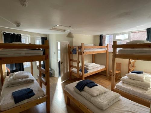 a dorm room with four bunk beds in it at Portland Outdoor Centre Hostel in Portland