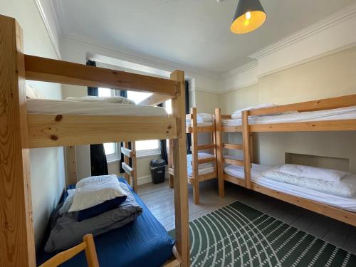 a room with two bunk beds and a blue bed at Portland Outdoor Centre Hostel in Portland