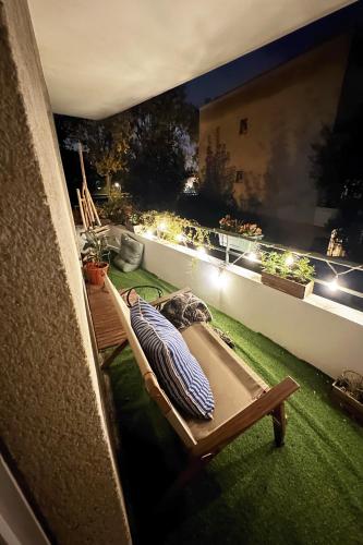 a bed on top of a balcony at night at uta house la plaine in Saint-Denis