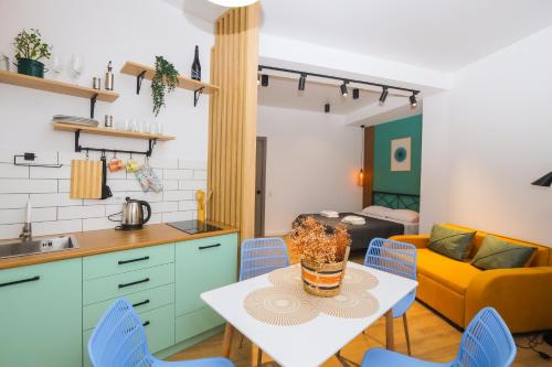 a kitchen and living room with a table and chairs at Mohika Aparthotel in Tbilisi City