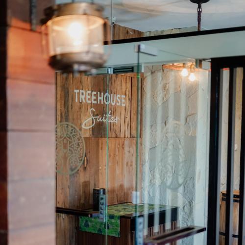 a window of a treehouse cafe with a sign on it at Treehouse Suites - Boutique Serviced Apartment in Jakarta