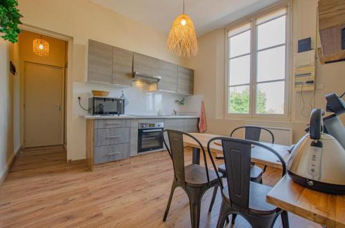 a kitchen and dining room with a table and chairs at Hebergement 10G490 in Sainte-Savine
