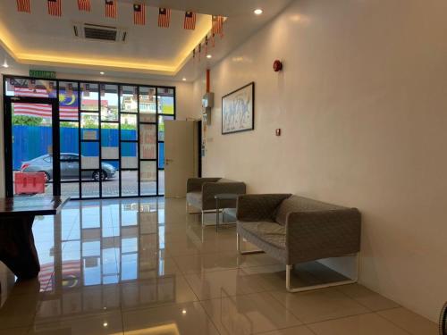 a waiting room with chairs and stained glass windows at TT Dorf Hotel Taiping in Taiping