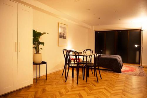 a dining room with a table and chairs in a room at #5 3stops to Shinjuku station stylish spacious studio apartment in Tokyo