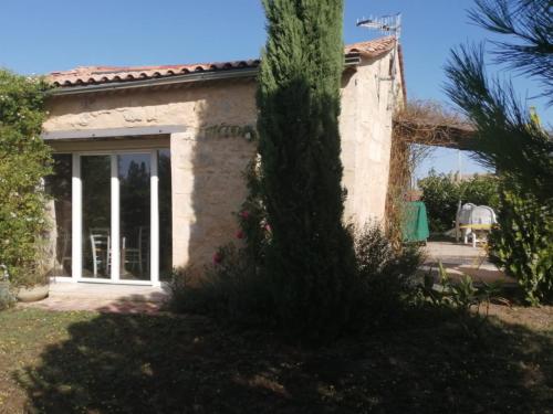 a house with a palm tree in the yard at La Place des Amis in Saint-Gervais