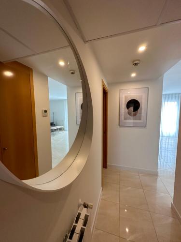 a hallway with a large circular mirror on the wall at AT home Señorio de Molina in Guadalajara