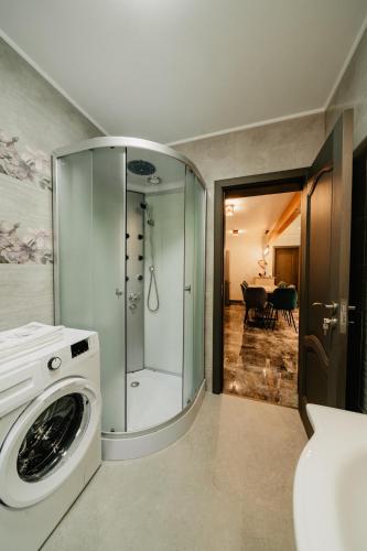 a bathroom with a washing machine and a dining room at Casa Diana in Vatra Dornei