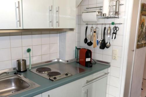 a kitchen with a sink and a counter top at Ferienwohnung mit Pfiff in Siegsdorf