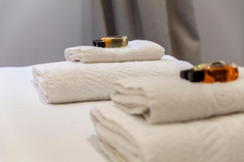 a stack of towels with rings on top of them at Bright King's Cross 2 bedroom flat with patio in London