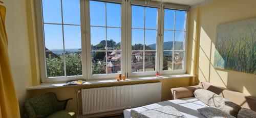 a room with a bed and a window with a view at Waldheim Lindenfels in Lindenfels