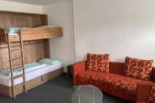 a room with a bunk bed and a couch at Wohnung Gruenberg 144 - Naviser Huette in Navis