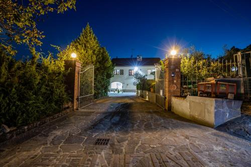 an empty driveway in front of a house at night at Sole Verde green house in Terricciola