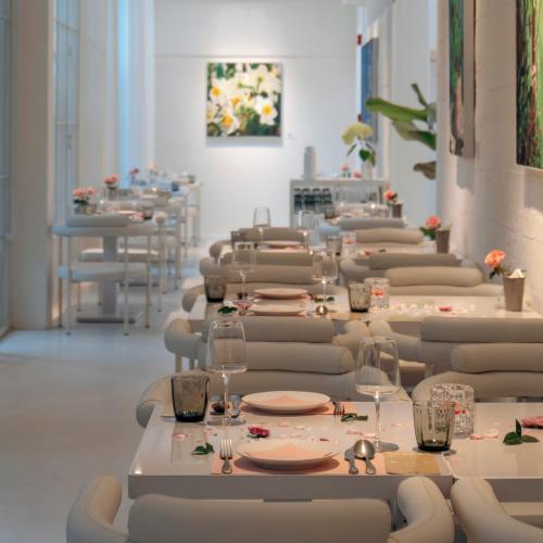 a row of tables with chairs and wine glasses at Shenzhen Loft Youth Hostel in Shenzhen