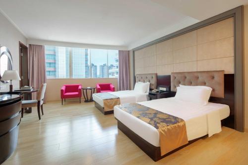Postel nebo postele na pokoji v ubytování Foshan Guanxin Hotel