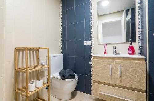 a bathroom with a toilet and a sink and a mirror at La Caracola - Espíritu libre A/A in El Altet