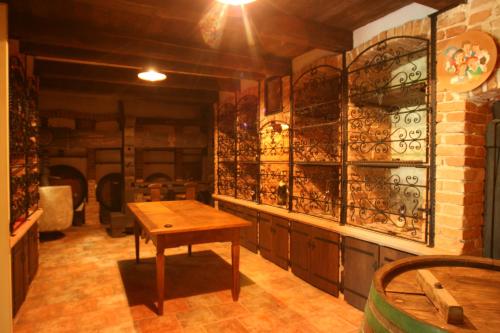 a room with a table and a wall of wine glasses at Villa Les with Hot tub & Sauna in Brežice