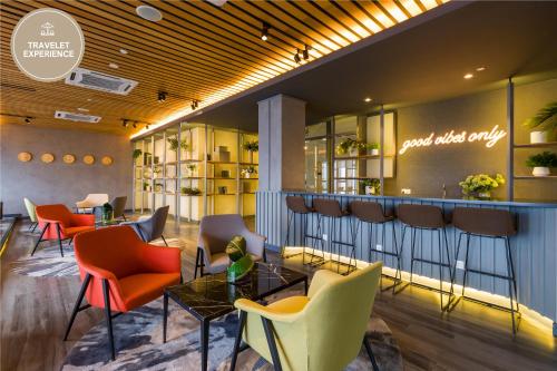 a lobby with colorful chairs and a bar at Ceylonz Suite KLCC, Travelet in Kuala Lumpur