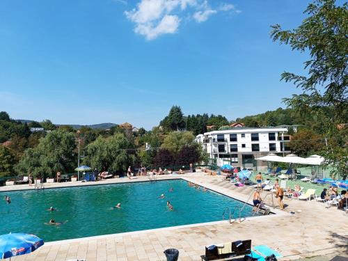 a large swimming pool with people swimming in it at Hedonica 11 Ema in Vrdnik