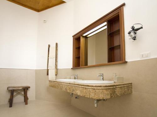 a bathroom with a sink and a mirror at B&B Virò in Campi Salentina