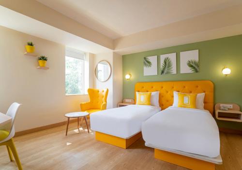 Postel nebo postele na pokoji v ubytování Bloom Hotel - Sector 19
