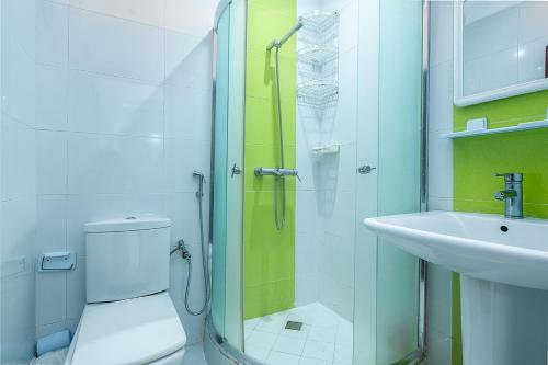 a bathroom with a shower and a toilet and a sink at Tangier Center Free Parking in Tangier