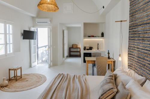a white living room with a couch and a table at Scorpios Beach in Monolithos