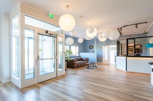 a living room with glass doors and a couch at Steger-Hüs Wohnung 07 in Rantum