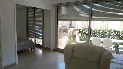 a living room with a view of a balcony at Large Studio 907T near Monte Carlo Casino Monaco in Monte Carlo