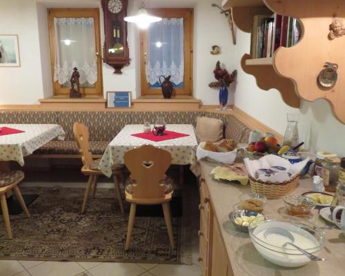 a kitchen with a table and a dining room at Agriturismo Kabishof in Funes