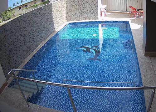 a swimming pool with a dolphin in the middle of it at Vualiku Hotel & Apartments in Nadi