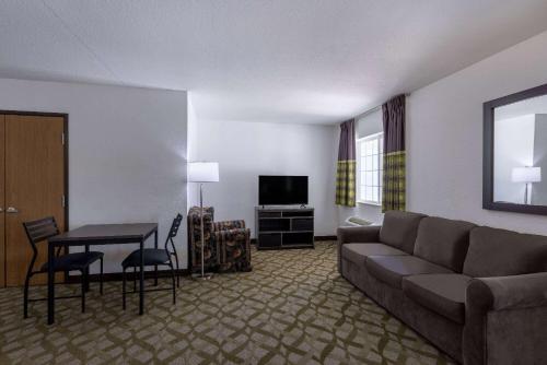 a living room with a couch and a table at Super 8 by Wyndham De Soto in De Soto