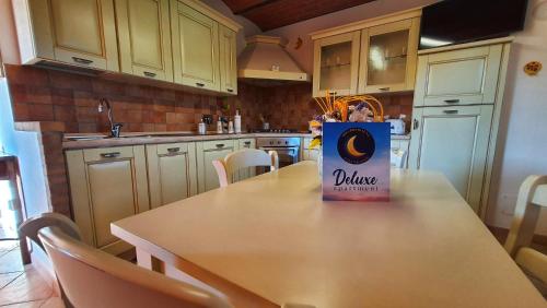 a kitchen with a table with a can of duke at Spicchio di Luna - Casa Vacanze in Albiano