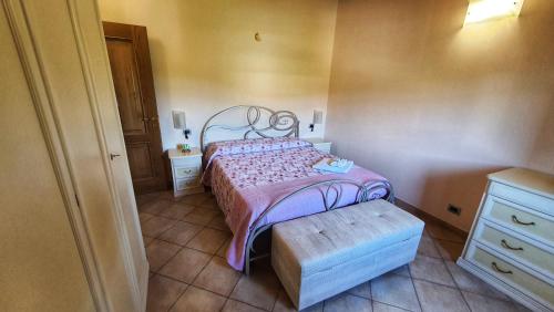 a small bedroom with a bed and a bench at Spicchio di Luna - Casa Vacanze in Albiano