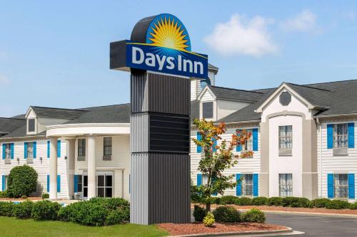 a days inn sign in front of a building at Days Inn by Wyndham Shallotte in Shallotte
