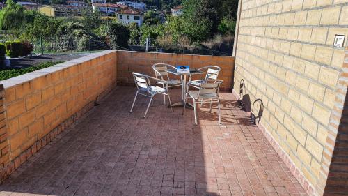 a table and chairs sitting on a brick patio at Spicchio di Luna - Casa Vacanze in Albiano