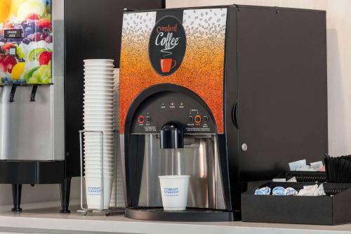 a coffee machine sitting on a counter with a cup at Days Inn by Wyndham Shallotte in Shallotte
