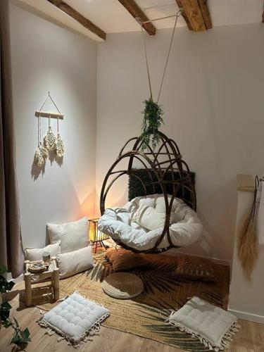 a living room with a basket and pillows on the floor at LE NOUMÉA, T2, Hyper-centre, Square de la Paix in Mâcon