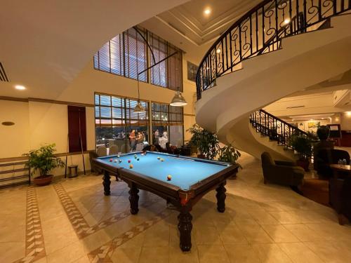 a pool table in a room with a staircase at Diamond Westlake Suites in Hanoi