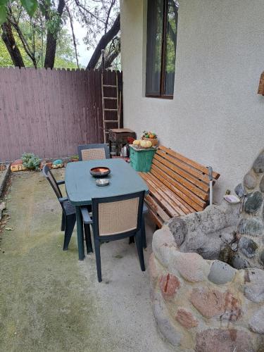 a patio with a table and chairs and a bench at Niki in Mtskheta