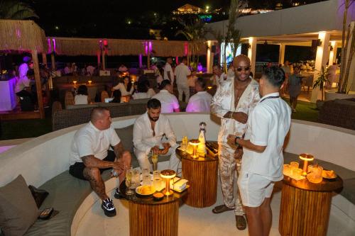 a group of people standing around a table with candles at DEJAVU 2.0 HOTEL BAJO KOMODO in Labuan Bajo