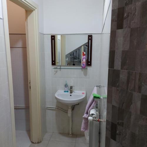 a small bathroom with a sink and a mirror at STATION KERDJOU TIARET in Tiaret