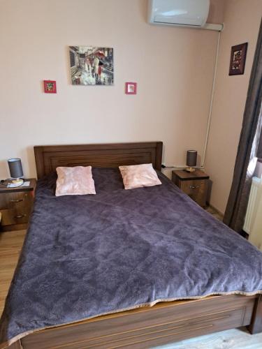 a bedroom with a large bed with two night stands at Niki in Mtskheta